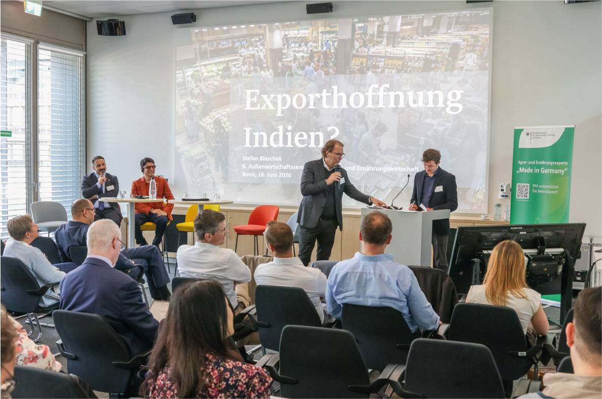 Plenum des 6. Außenwirtschaftsseminars der Agrar- und Ernährungswirtschaft in Bonn. Vor zahlreichen Teilnehmern diskutieren Referenten auf der Bühne über internationale Marktchancen für deutsche Lebensmittel. Auf der Präsentationsfolie steht das Thema „Exporthoffnung Indien?“, das sich mit Potenzialen und Herausforderungen des indischen Marktes für die deutsche Agrar- und Ernährungswirtschaft beschäftigt. Die Veranstaltung dient dem Austausch zu Exportförderung, Marktzugang und globalen Handelsentwicklungen.