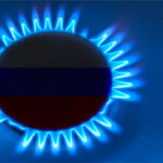 Eine brennende Gasflamme auf einem Herd, in deren Mitte die russische Flagge eingeblendet ist. Das Bild symbolisiert die Abhängigkeit von russischen Gaslieferungen und die energiepolitische Dimension internationaler Beziehungen.
