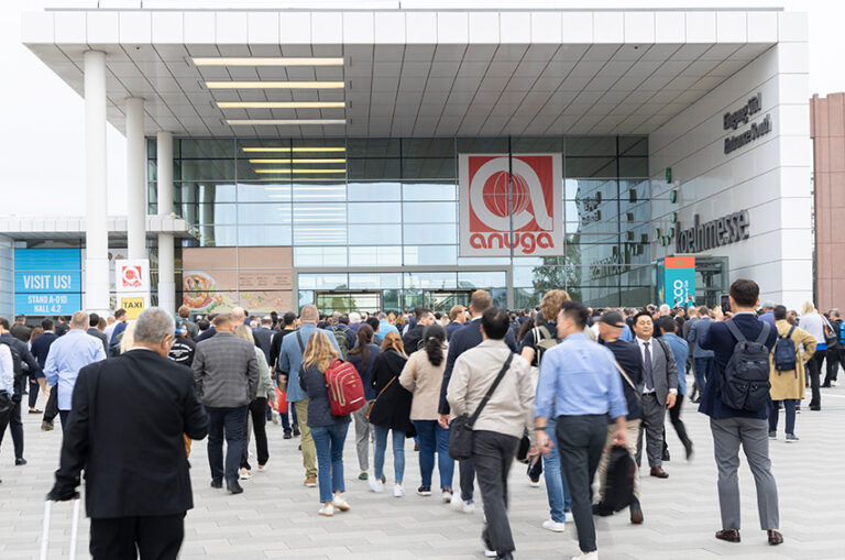 Besucherinnen und Besucher strömen zum Eingang der Koelnmesse zur Anuga, der weltgrößten Fachmesse für Lebensmittel und Getränke.